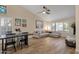 Bright living room with wood floors, ceiling fan, comfortable sofa, and a dining area with seating at 3842 W Ironwood Dr, Chandler, AZ 85226