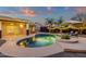 This backyard includes a kidney shaped pool, patio with lights, lounge chairs and desert landscaping at 3842 W Ironwood Dr, Chandler, AZ 85226