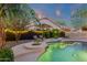Inviting backyard pool with ambient lighting, lush landscaping, and a serene atmosphere at 3842 W Ironwood Dr, Chandler, AZ 85226