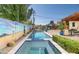 Picturesque backyard with a pool, spa, vibrant mural, and ample lounging space at 39 E Hoover Ave, Phoenix, AZ 85004
