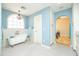 Charming bathroom with a clawfoot tub, arched window, black and white tile floor and neutral blue walls at 39 E Hoover Ave, Phoenix, AZ 85004