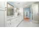 Bathroom featuring double sinks, marble countertops, tiled shower, and ample cabinet space at 39 E Hoover Ave, Phoenix, AZ 85004
