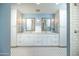 Bathroom featuring double sinks, marble countertops, and a blue accent wall at 39 E Hoover Ave, Phoenix, AZ 85004