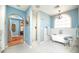 Bright, spacious bathroom with a clawfoot tub, tiled shower, and stylish black-and-white tiled flooring at 39 E Hoover Ave, Phoenix, AZ 85004