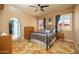 Comfortable bedroom featuring an iron bed frame, ceiling fan, and two windows letting in plenty of natural light at 39 E Hoover Ave, Phoenix, AZ 85004