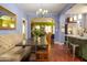 Charming dining area with a rustic wood table and banquette seating adjacent to the modern kitchen at 39 E Hoover Ave, Phoenix, AZ 85004