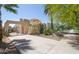 Side view of stucco home featuring desert landscaping and a concrete driveway surrounded by mature trees at 39 E Hoover Ave, Phoenix, AZ 85004