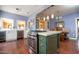 Spacious kitchen with stainless steel appliances, island and adjacent dining area with hardwood floors at 39 E Hoover Ave, Phoenix, AZ 85004
