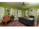 View of a living room featuring a fireplace, wood floors, and a vintage piano bathed in natural light at 39 E Hoover Ave, Phoenix, AZ 85004