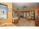 Bright living room with sliding glass doors leading to the patio, comfortable seating, and a ceiling fan at 39 E Hoover Ave, Phoenix, AZ 85004