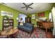Eclectic living room with colorful walls, vintage furnishings, and a ceiling fan for added comfort at 39 E Hoover Ave, Phoenix, AZ 85004