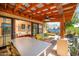Inviting outdoor patio with dining and seating, wooden beams, and access to the pool and backyard at 39 E Hoover Ave, Phoenix, AZ 85004