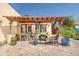 Relaxing outdoor patio area with wooden pergola, seating, and views of the backyard at 39 E Hoover Ave, Phoenix, AZ 85004