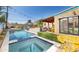 Beautiful pool area with a spa, nearby seating, and well-kept landscaping at 39 E Hoover Ave, Phoenix, AZ 85004