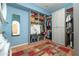 Functional walk-in closet with organized shelving and clothing racks and a practical mirror at 39 E Hoover Ave, Phoenix, AZ 85004