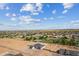 Wide aerial shot showing homes with large lots in a suburban neighborhood with mountains on the horizon at 3989 E Freeman Ln, San Tan Valley, AZ 85140