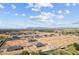 A serene view capturing a neighborhood with homes on expansive lots, nestled among open fields and distant mountain vistas at 3989 E Freeman Ln, San Tan Valley, AZ 85140