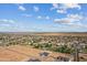 Expansive aerial view showcasing a neighborhood with varied homes and large lots, set against a backdrop of distant mountains at 3989 E Freeman Ln, San Tan Valley, AZ 85140