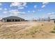 Expansive backyard featuring a modern home, desert landscape, and steel beam construction at 3989 E Freeman Ln, San Tan Valley, AZ 85140