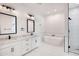 Bright and modern bathroom featuring double vanities, sleek fixtures, and a freestanding tub at 3989 E Freeman Ln, San Tan Valley, AZ 85140