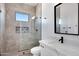 Contemporary bathroom features a tiled shower, glass door, and a modern vanity at 3989 E Freeman Ln, San Tan Valley, AZ 85140