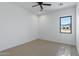 Bedroom with neutral carpet, window, ceiling fan, and white walls at 3989 E Freeman Ln, San Tan Valley, AZ 85140