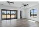 Bright bedroom with wood flooring, ceiling fans, and sliding glass doors leading to the backyard at 3989 E Freeman Ln, San Tan Valley, AZ 85140