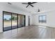 Bright bedroom featuring a ceiling fan, backyard access and bathroom at 3989 E Freeman Ln, San Tan Valley, AZ 85140