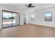 Spacious bedroom with wood floors, large windows, and access to a patio at 3989 E Freeman Ln, San Tan Valley, AZ 85140
