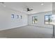 Large bedroom with carpeted floors, ceiling fan, and large windows with a view at 3989 E Freeman Ln, San Tan Valley, AZ 85140