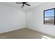 Bedroom with neutral carpet, window, ceiling fan, and white walls at 3989 E Freeman Ln, San Tan Valley, AZ 85140