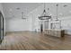 Expansive great room showcasing an open layout, wood floors, and abundant natural light from large windows at 3989 E Freeman Ln, San Tan Valley, AZ 85140