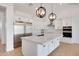 Bright kitchen featuring white cabinets, stainless steel appliances, and a large center island with marble countertops at 3989 E Freeman Ln, San Tan Valley, AZ 85140
