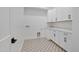 Well-appointed laundry room with stylish tile floor, white cabinets, and a durable countertop for folding and sorting at 3989 E Freeman Ln, San Tan Valley, AZ 85140