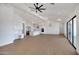 Spacious living room featuring a modern ceiling fan, recessed lighting, and large windows for ample natural light at 3989 E Freeman Ln, San Tan Valley, AZ 85140