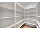 Walk-in pantry with spacious shelving and light wood floors, perfect for storing all your kitchen essentials at 3989 E Freeman Ln, San Tan Valley, AZ 85140