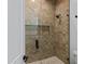 Modern shower featuring herringbone tile, glass door, and matte black fixtures at 3989 E Freeman Ln, San Tan Valley, AZ 85140