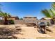 Backyard with brick patio, grill, block wall fence, and some plants at 40264 W Lococo St, Maricopa, AZ 85138