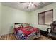 Cozy bedroom featuring a ceiling fan, window with blinds, and comfortable bedding at 40264 W Lococo St, Maricopa, AZ 85138
