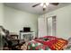 Cozy bedroom featuring a ceiling fan, closet, and laminate wood flooring at 40264 W Lococo St, Maricopa, AZ 85138
