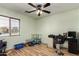 Versatile bedroom space with natural light, ceiling fan, and ample room for customization at 40264 W Lococo St, Maricopa, AZ 85138