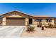 Charming single-story home featuring a two-car garage and low-maintenance desert landscaping at 40264 W Lococo St, Maricopa, AZ 85138