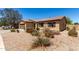Well maintained single-story home with desert landscaping and shutters on windows at 40264 W Lococo St, Maricopa, AZ 85138