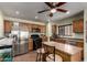 Well-equipped kitchen with stainless steel appliances, center island, and ample cabinetry at 40264 W Lococo St, Maricopa, AZ 85138