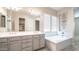 Bright bathroom with double vanity, soaking tub, and decorative details at 4323 E Wheaton St, Gilbert, AZ 85295