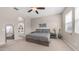 Comfortable bedroom featuring a queen bed, soft lighting, and ensuite bathroom at 4323 E Wheaton St, Gilbert, AZ 85295