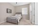Bedroom with carpet, metal bed frame, window with blinds, and doorway to another room at 4323 E Wheaton St, Gilbert, AZ 85295