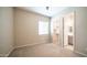 Neutral bedroom with carpet flooring, window with blinds, and view to walk-in closet and ensuite at 4323 E Wheaton St, Gilbert, AZ 85295