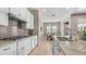 Modern kitchen features sleek appliances, ample counter space, and stylish tile backsplash, seamlessly connected to the dining area at 4323 E Wheaton St, Gilbert, AZ 85295