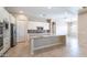 Bright and spacious kitchen featuring an island, white cabinets, and stainless steel appliances at 4323 E Wheaton St, Gilbert, AZ 85295